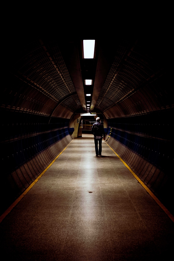 man walking in a tunnel