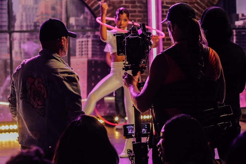 guys filming a woman dancing